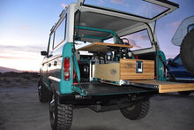Load image into Gallery viewer, Overland Vehicle Storage system for SUV, Jeep JK / JL, 4Runner. View of Trail Kitchen Upgrade Pullout in action on the trail.