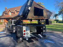Load image into Gallery viewer, Tribe Basecamp Overland Trailer.  View of rear Fridge / cooler slide and side view of Tuff Stuff Alpha rooftop tent