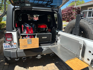 Overland Vehicle Storage system for SUV, Jeep Jk / JL, 4Runner. View of  system fully loaded in rear of Jeep JK, matched with Outback Adventure tailgate table with bamboo cutting board.